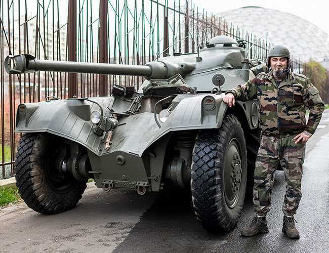 A driver and his Panhard EBR tank in a dynamic demonstration at the Rétromobile show