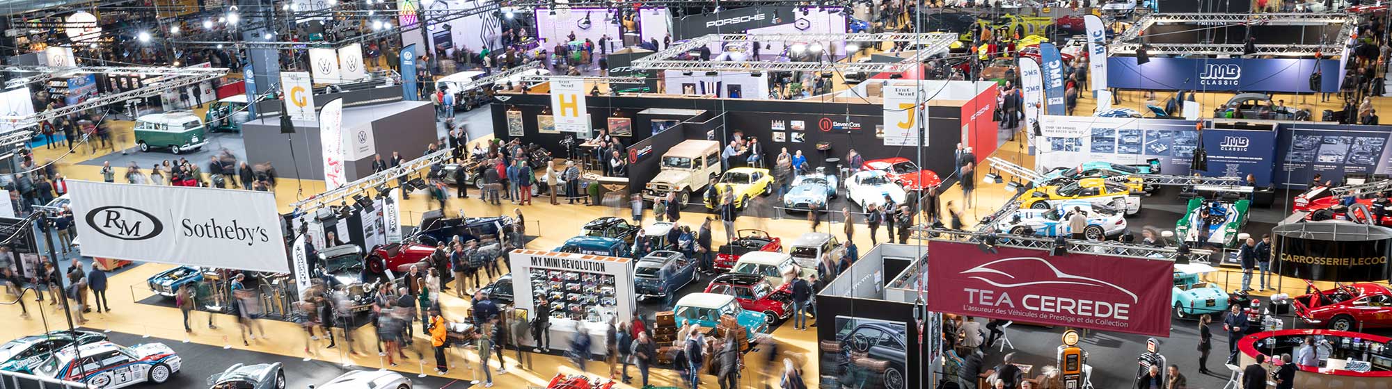 Aerial photo of the Rétromobile show with numerous stands and a crowd of visitors