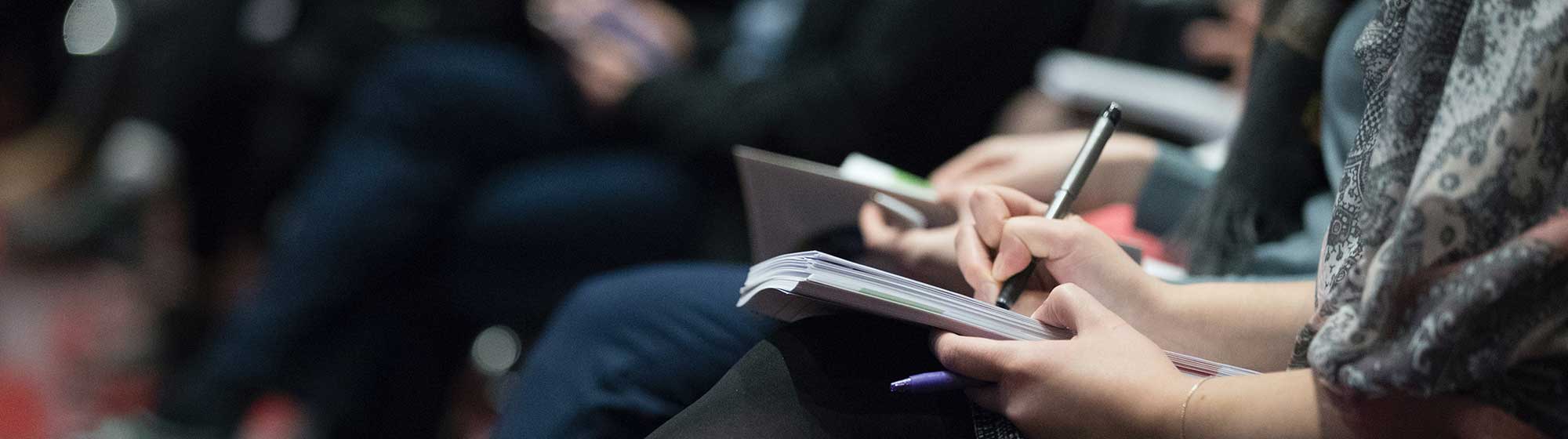 Journalist taking notes at an event