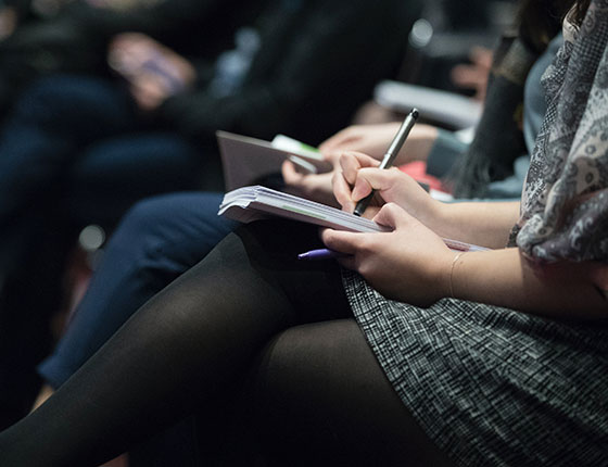 Journalist taking notes at an event