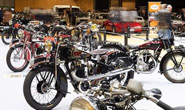 Motos de collection au sein d'une zone d'exposition à Rétromobile